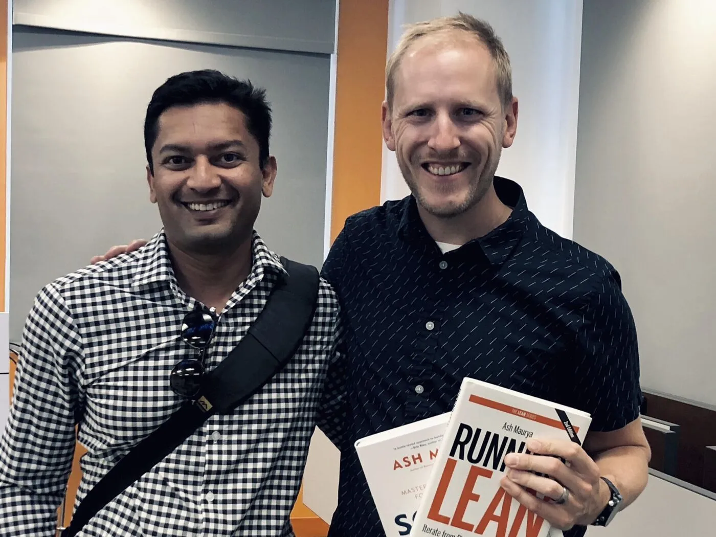 Marc Krejci smiling beside Ash Maurya, author of Running Lean.